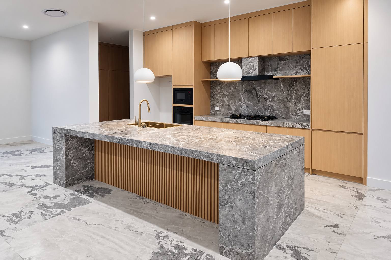 Grey stone-look porcelain waterfall island with timber batten panel, fabricated by APD